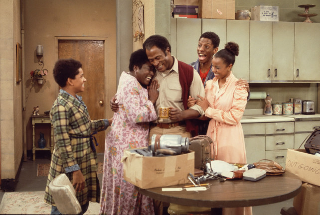 From left, American actors Ralph Carter, Esther Rolle (1920 - 1998), John Amos, Jimmie Walker, and BernNadette Stanis gather in the kitchen in a scene from the television show 'Good Times,' Los Angeles, California, 1975. (Photo by CBS Photo Archive/Getty Images)